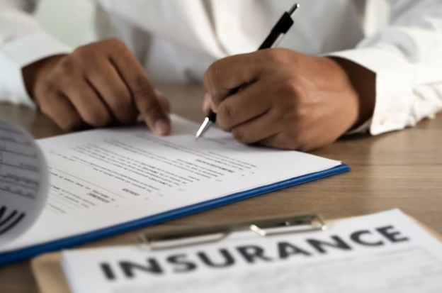 Man signing auto insurance policy